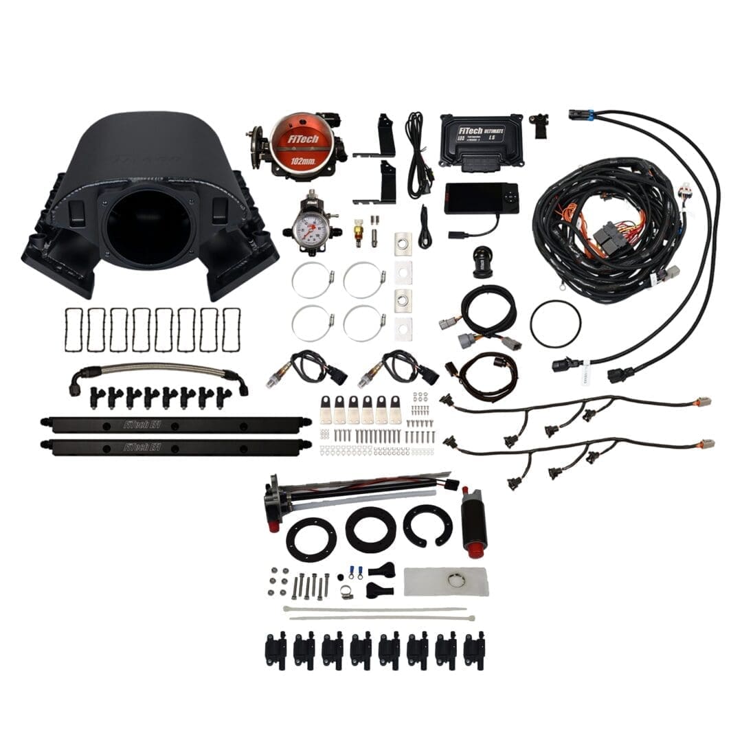 Car engine components and accessories laid out.