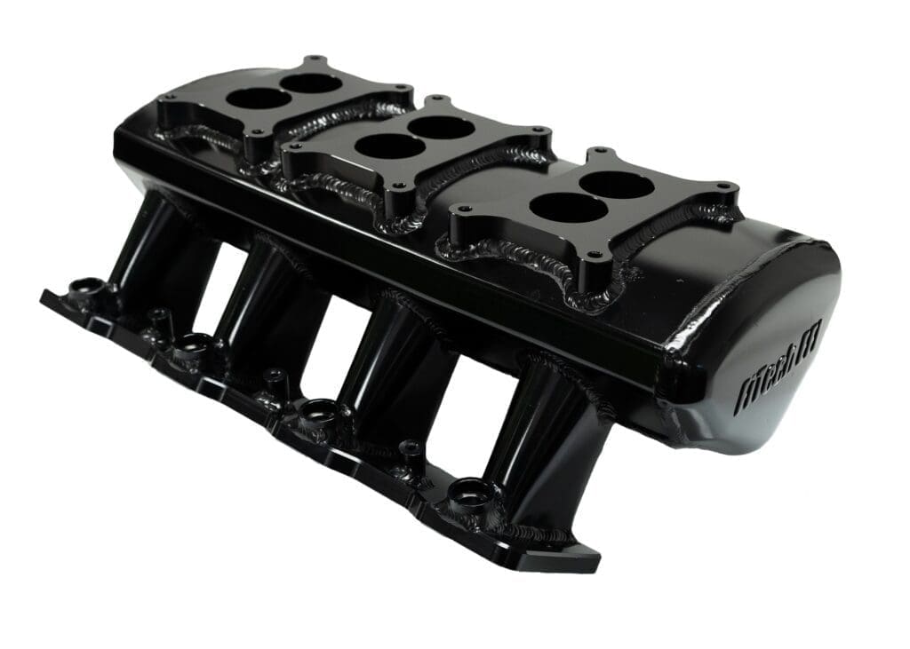 Black engine intake manifold on white background.