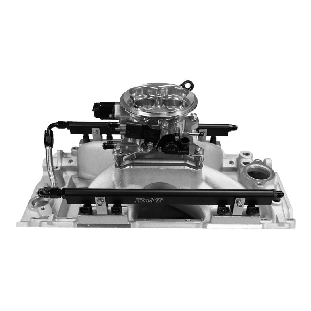 Carburetor on intake manifold, isolated view.