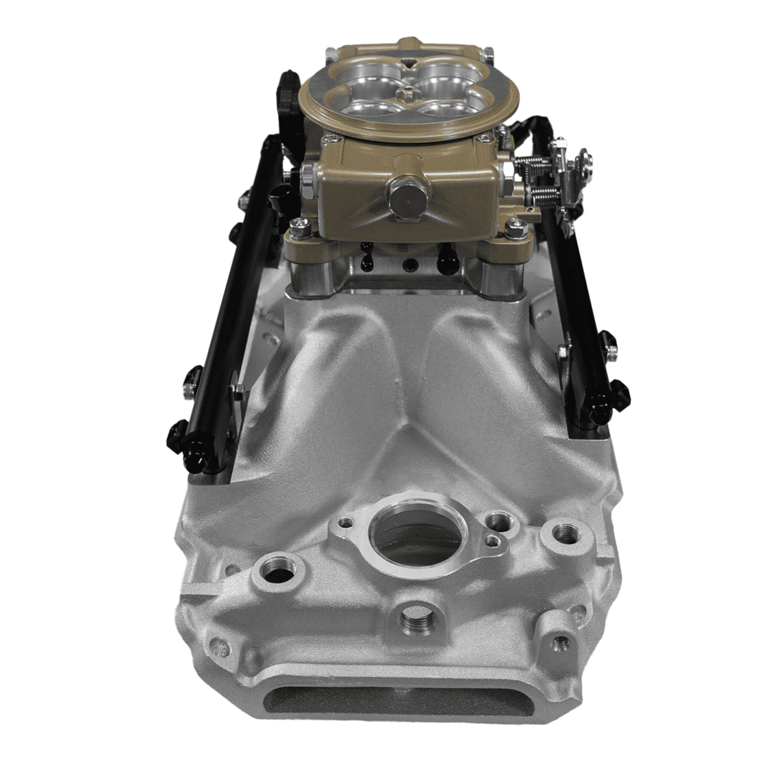 Engine intake manifold with carburetor on top.