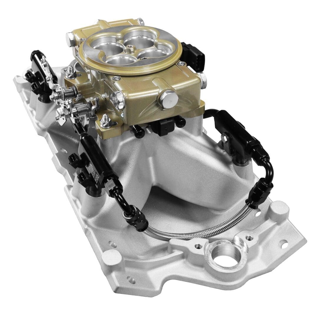 Carburetor on silver intake manifold, close-up.