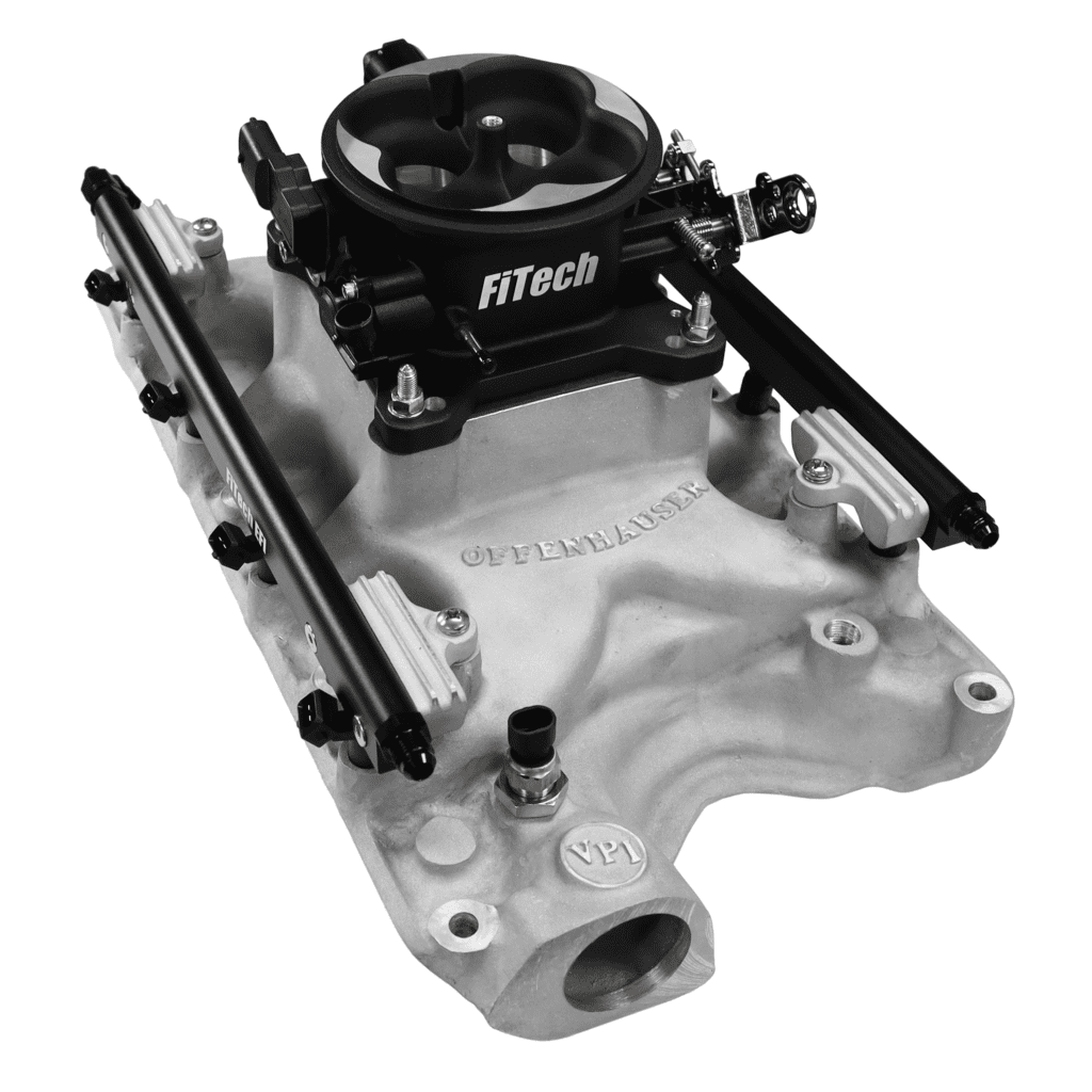 FiTech carburetor on automotive intake manifold.