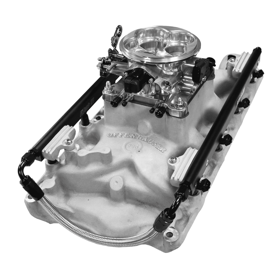 Car engine intake manifold and carburetor assembly.