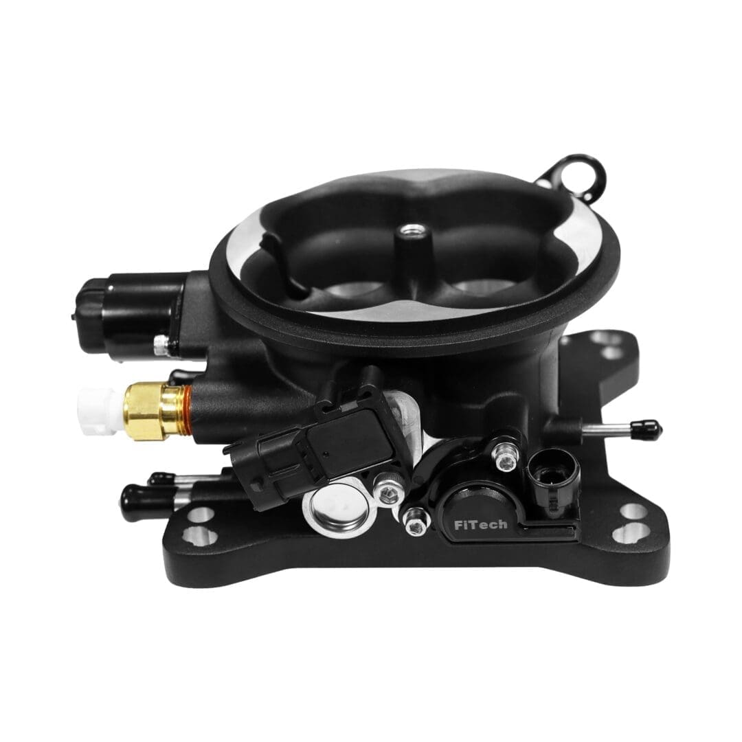 Carburetor assembly with various attached components.