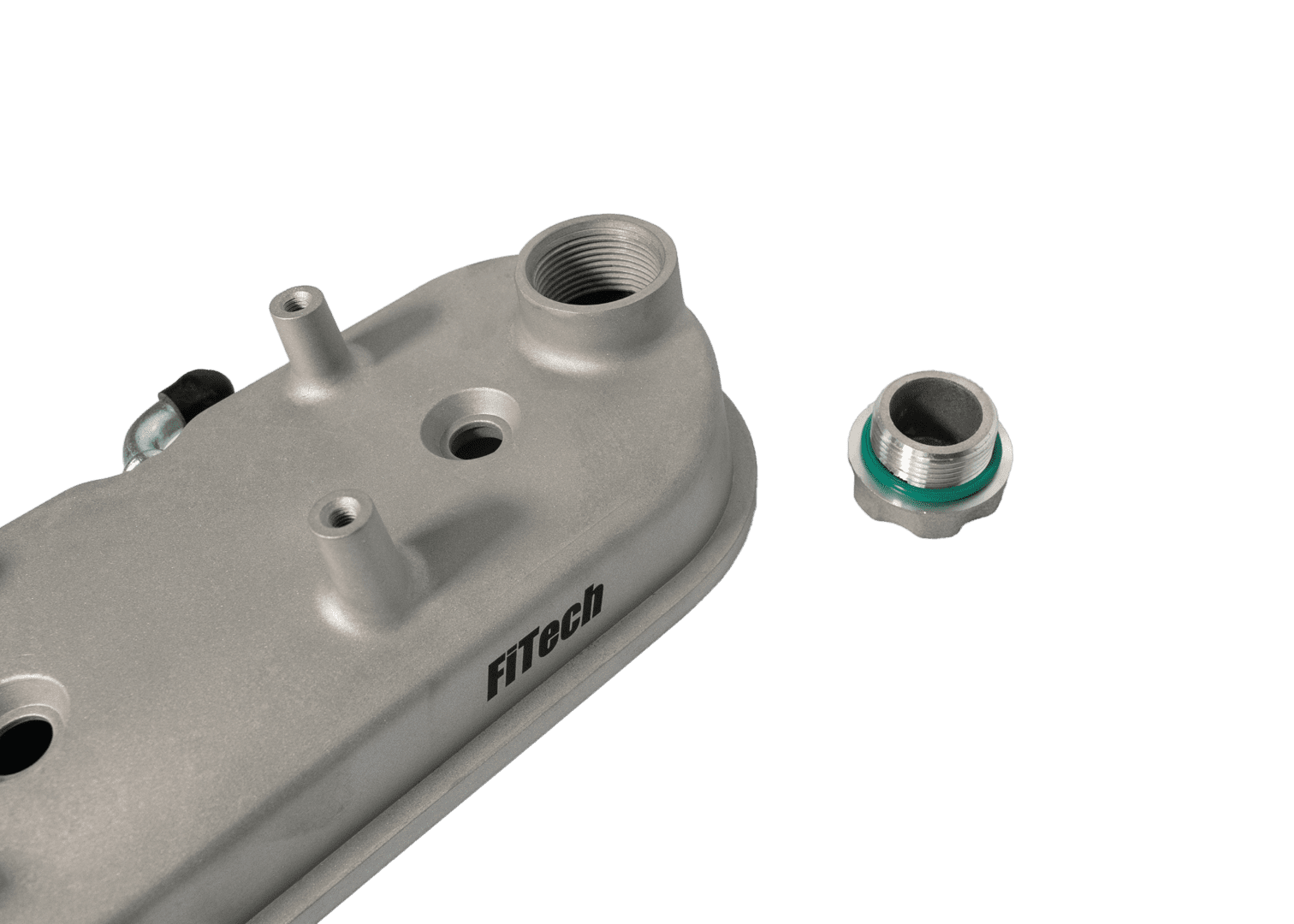 FiTech auto part and connector on black.