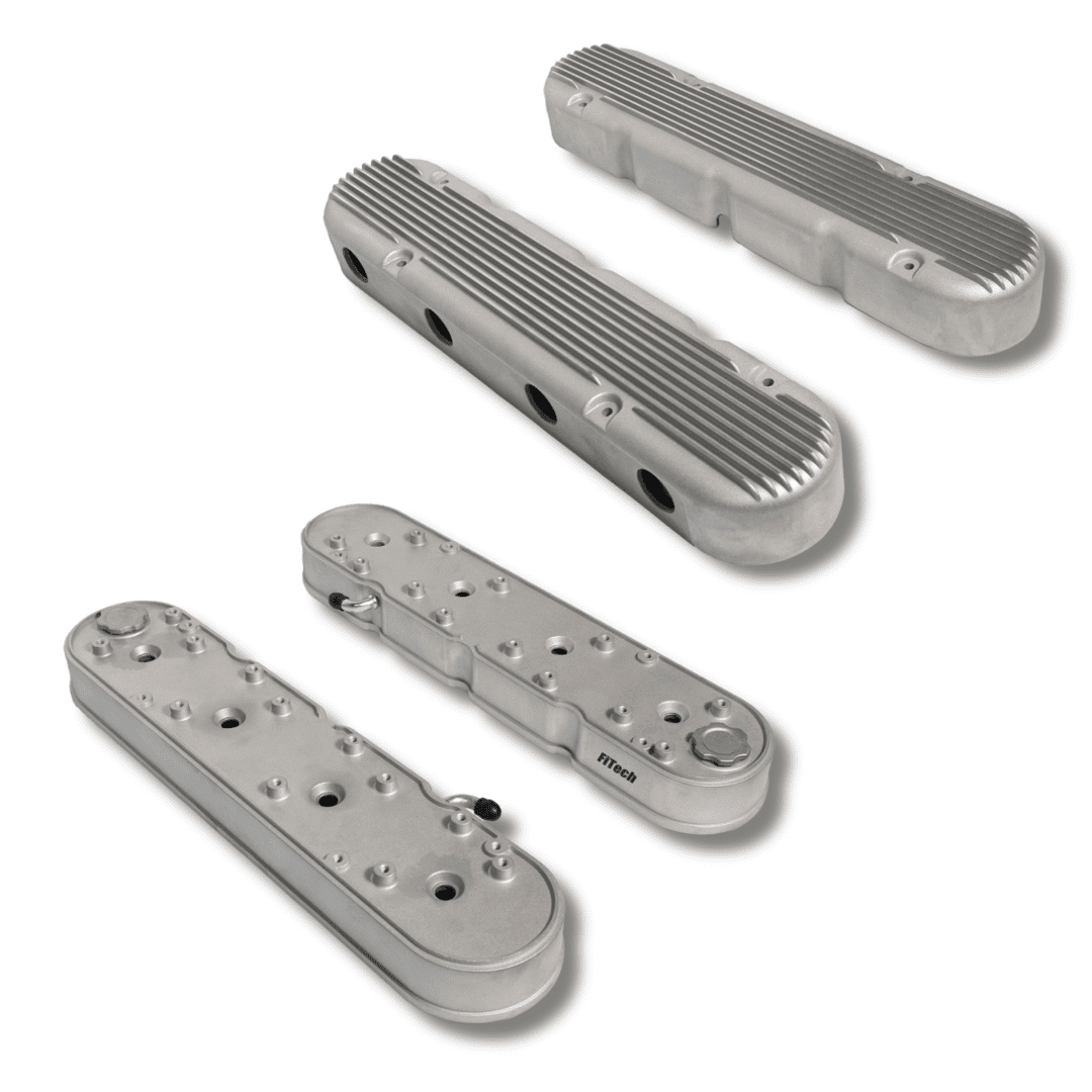 Silver engine valve covers, ribbed and smooth.