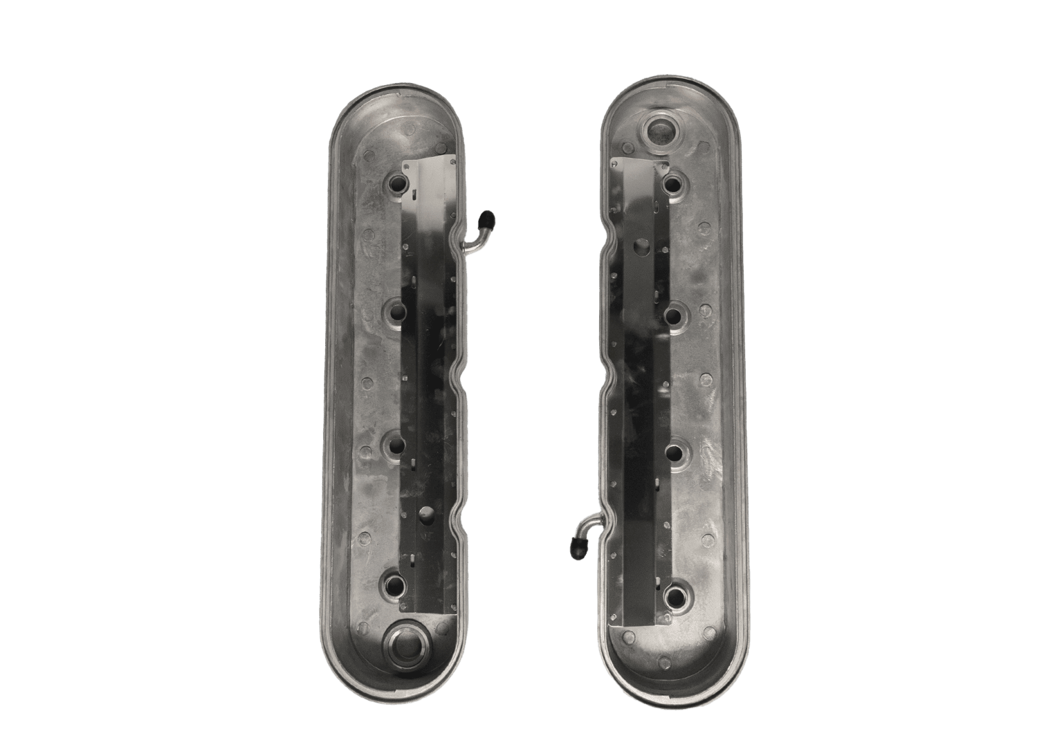 Two metal engine valve covers on black.