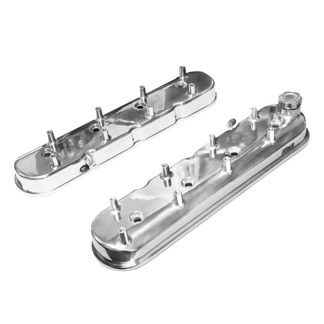 Two chrome engine valve covers isolated.