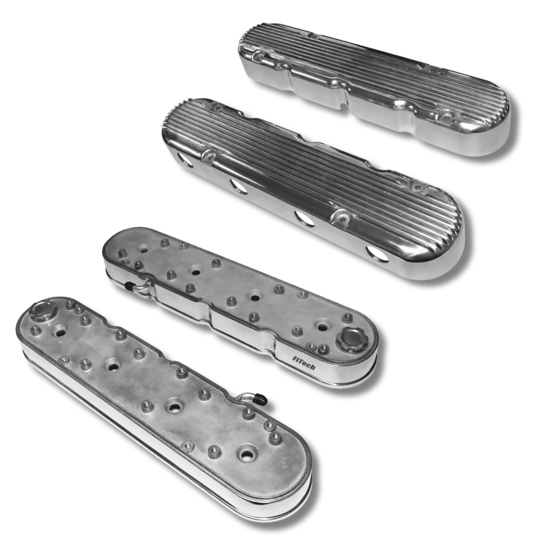 Four metallic automotive engine valve covers.