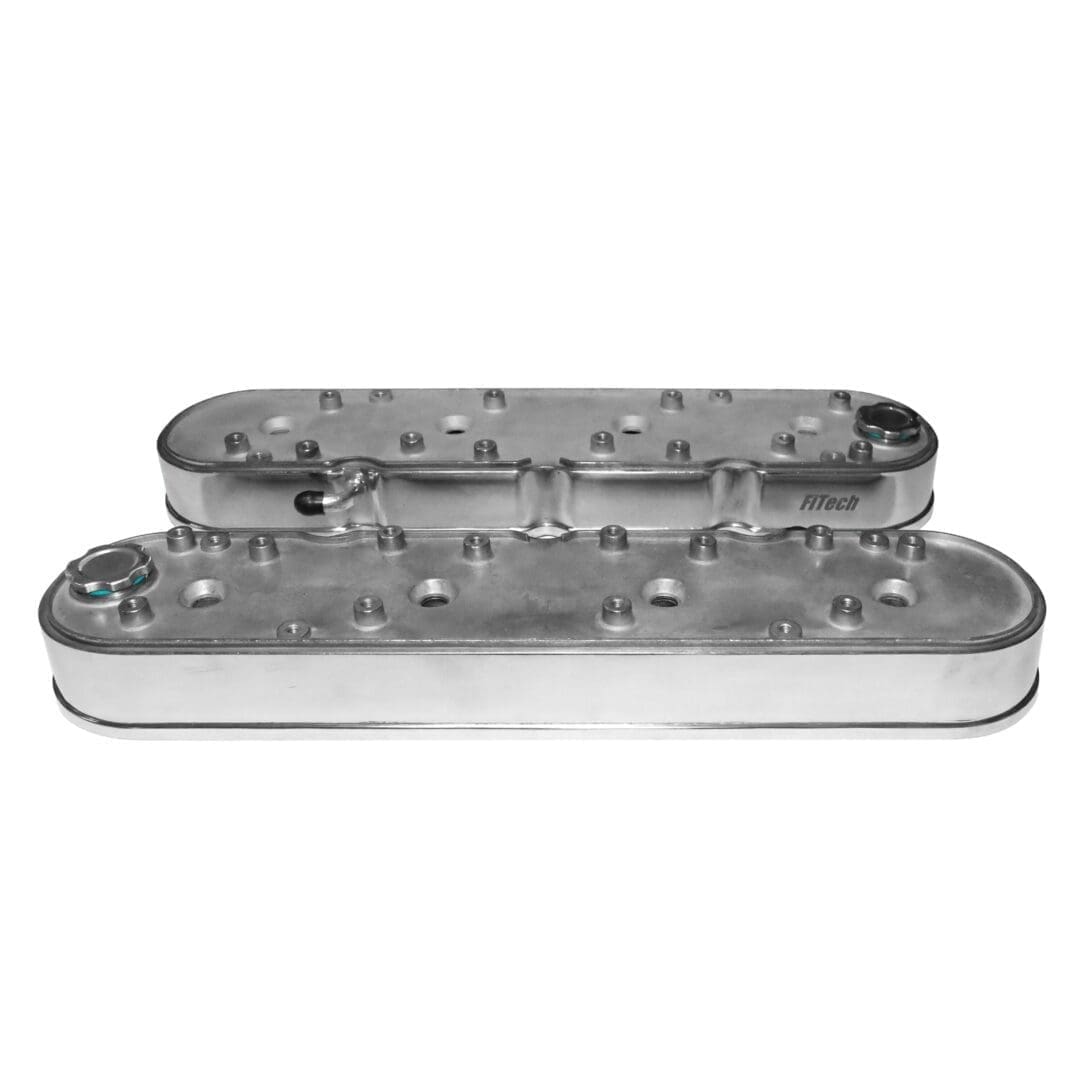 Silver engine valve covers on white background.