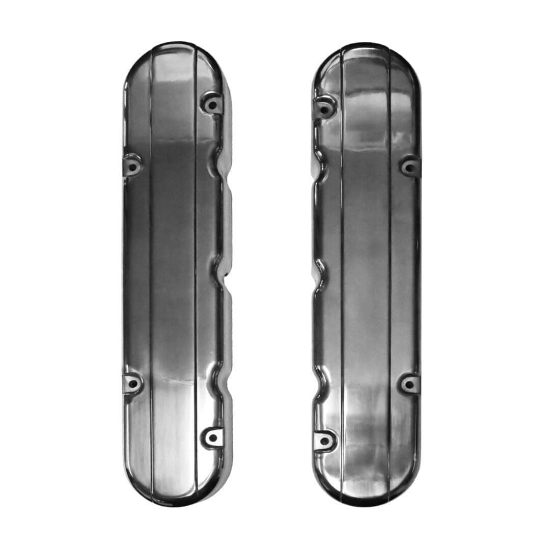 Two chrome engine valve covers, vertical alignment.