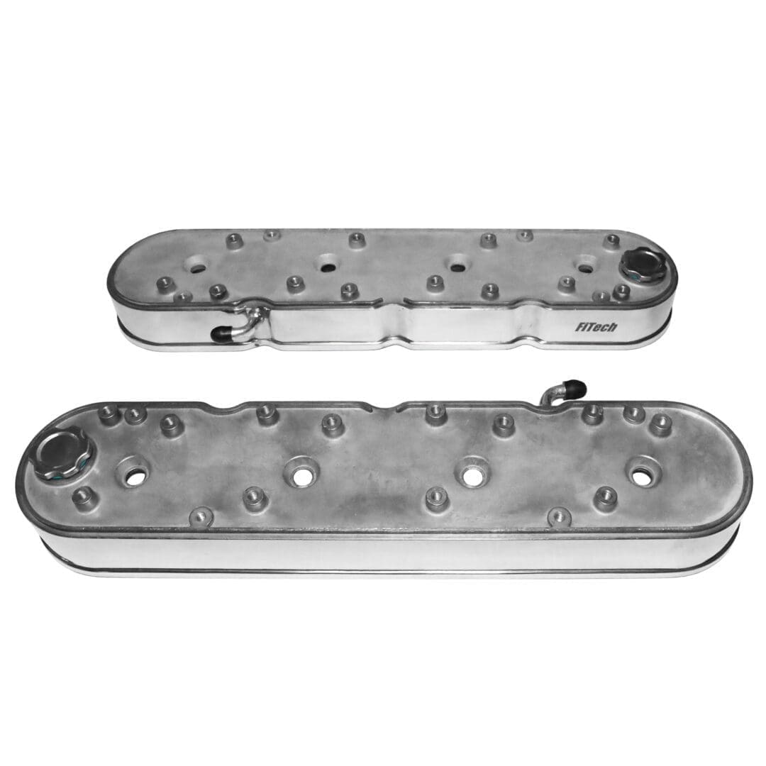 Two metal engine valve covers, silver color.