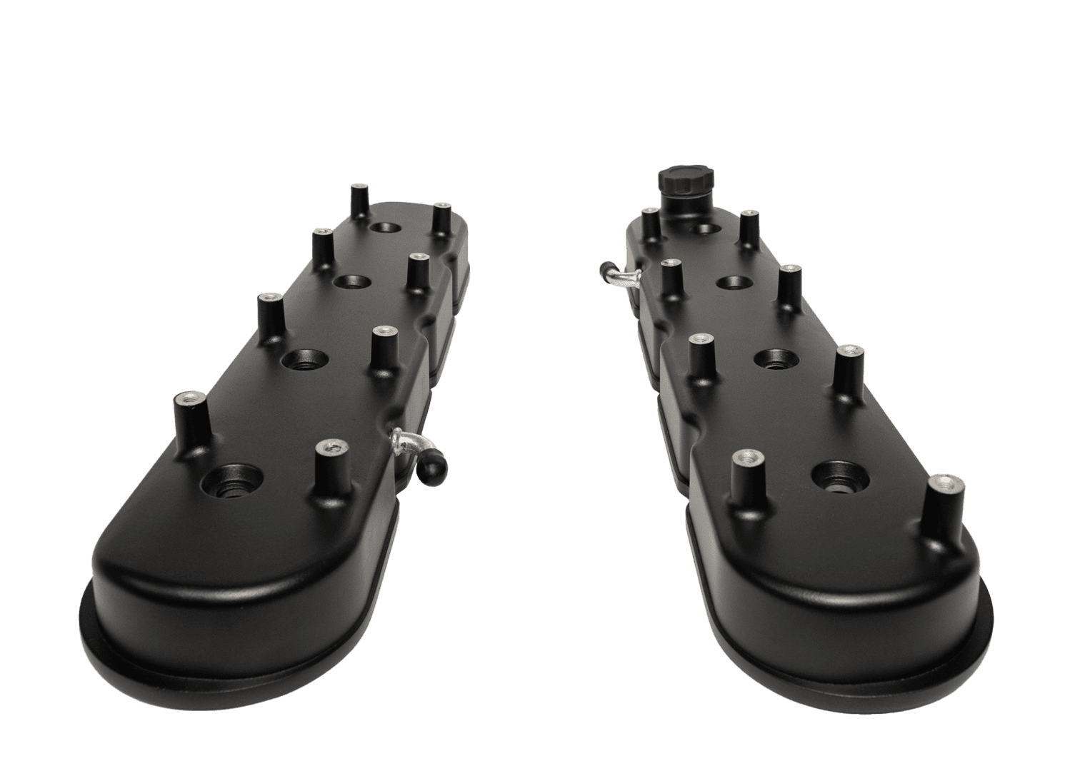Black engine valve covers on black background.