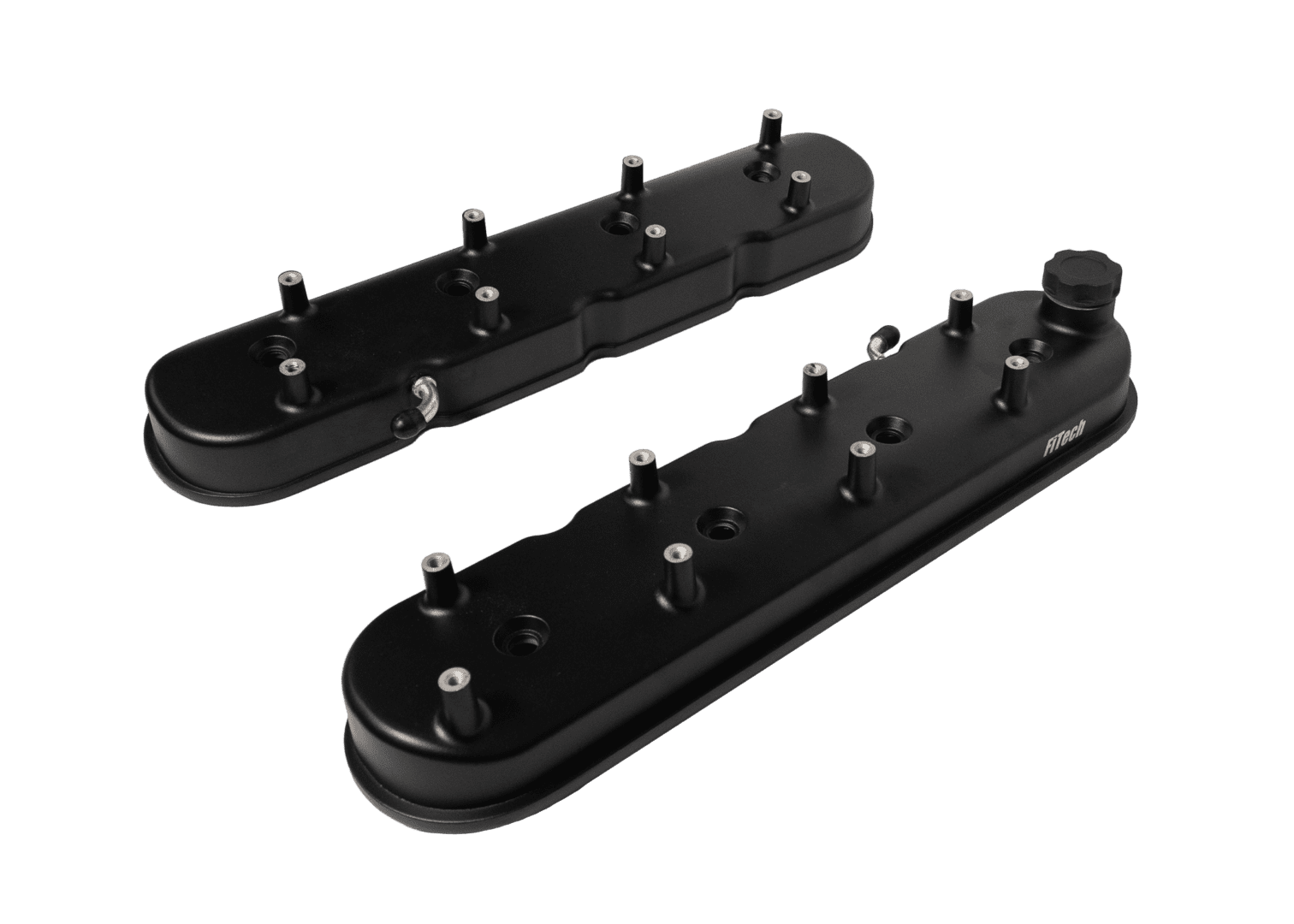 Black engine valve covers on black background.