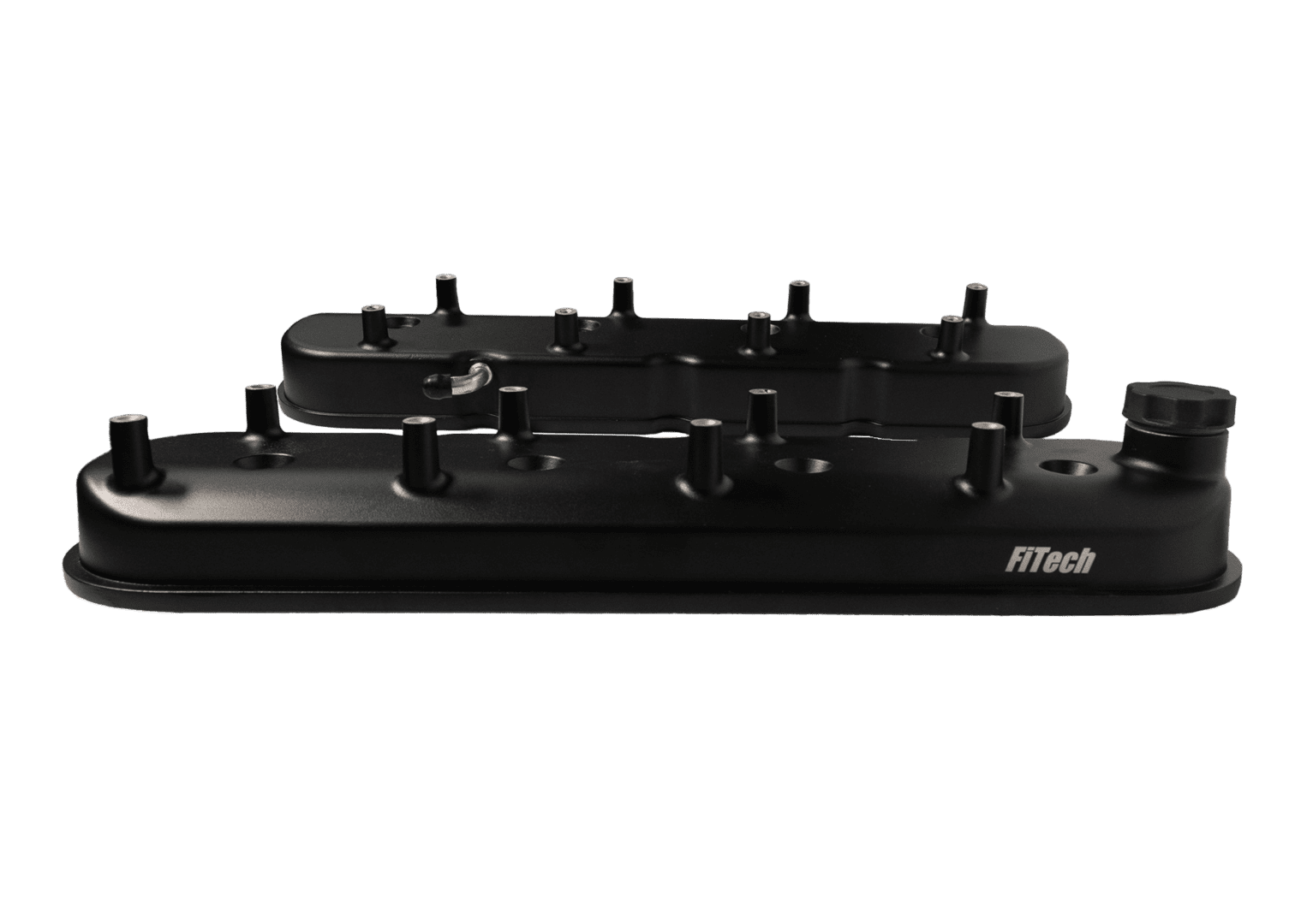 Black engine valve covers on black background.