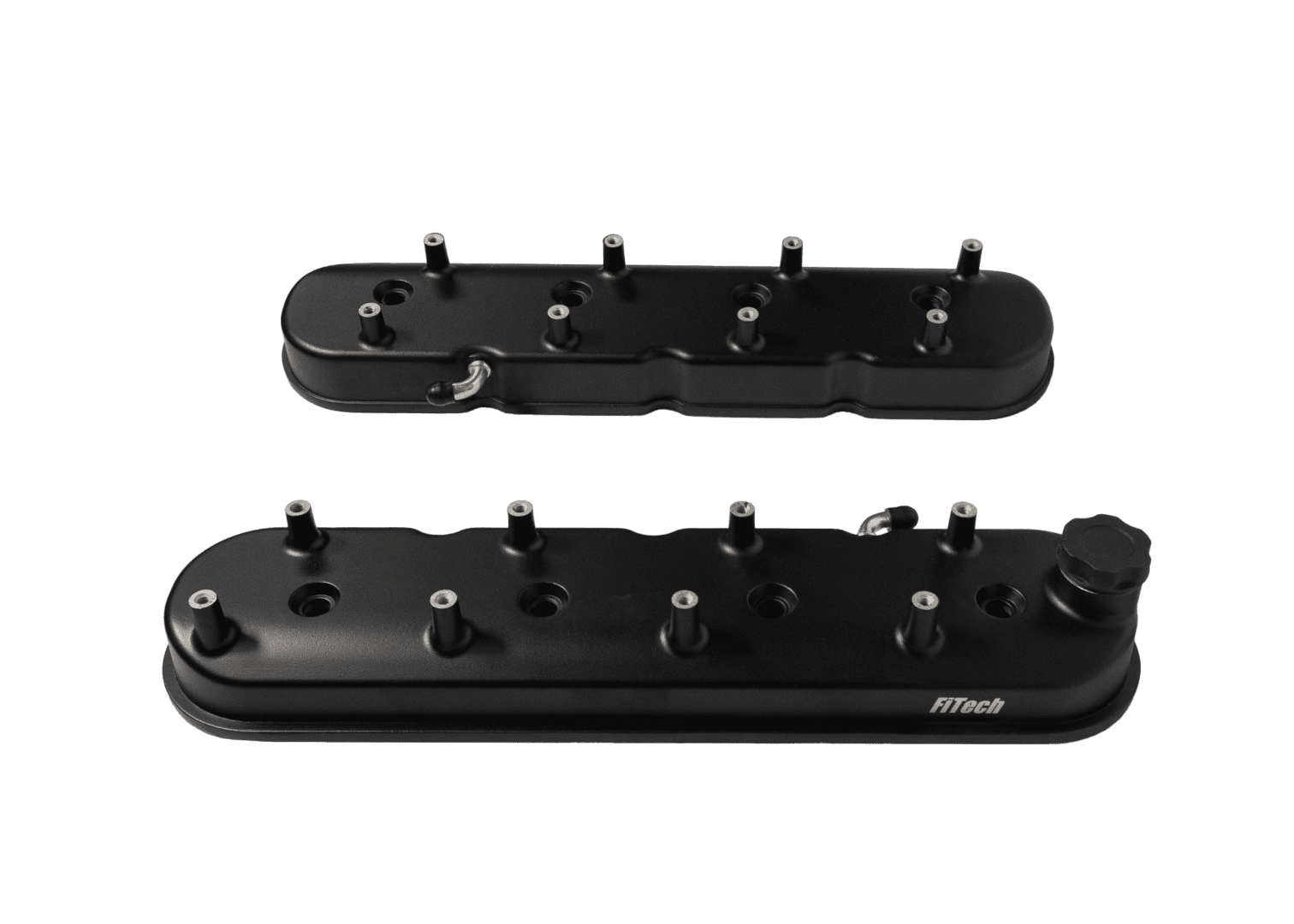 Black engine valve covers on black background.