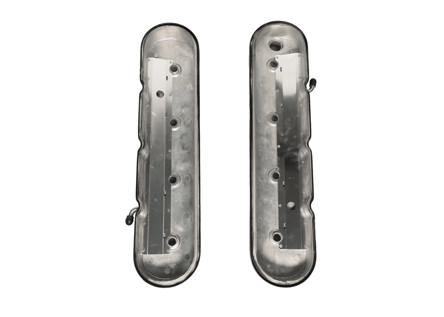 Silver metal engine covers on black background.