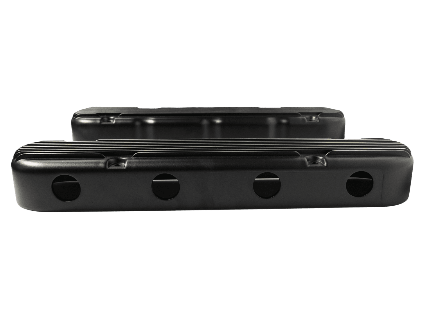 Black engine valve covers on black background.