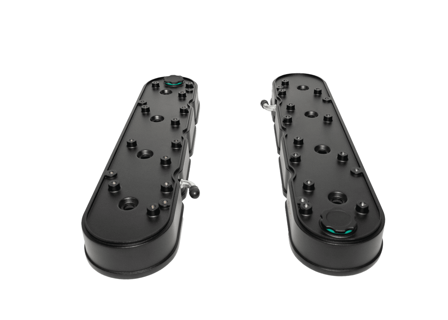 Two black mechanical components on black background.