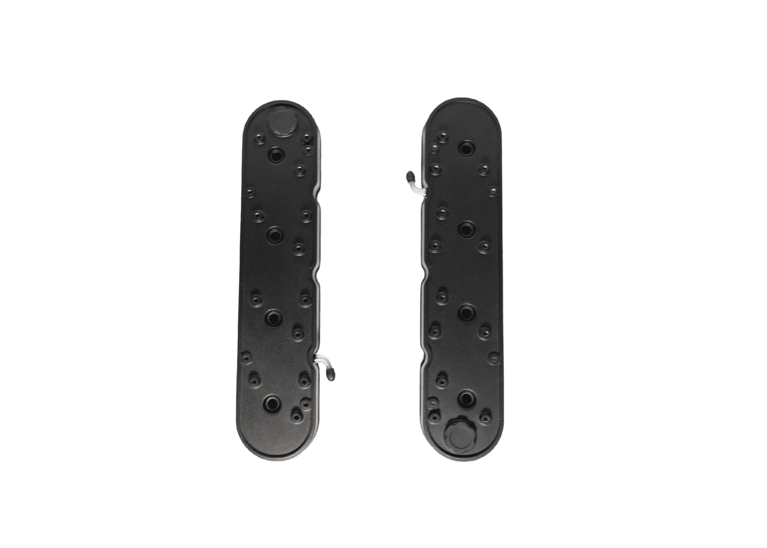 Two black skateboard truck baseplates on black.