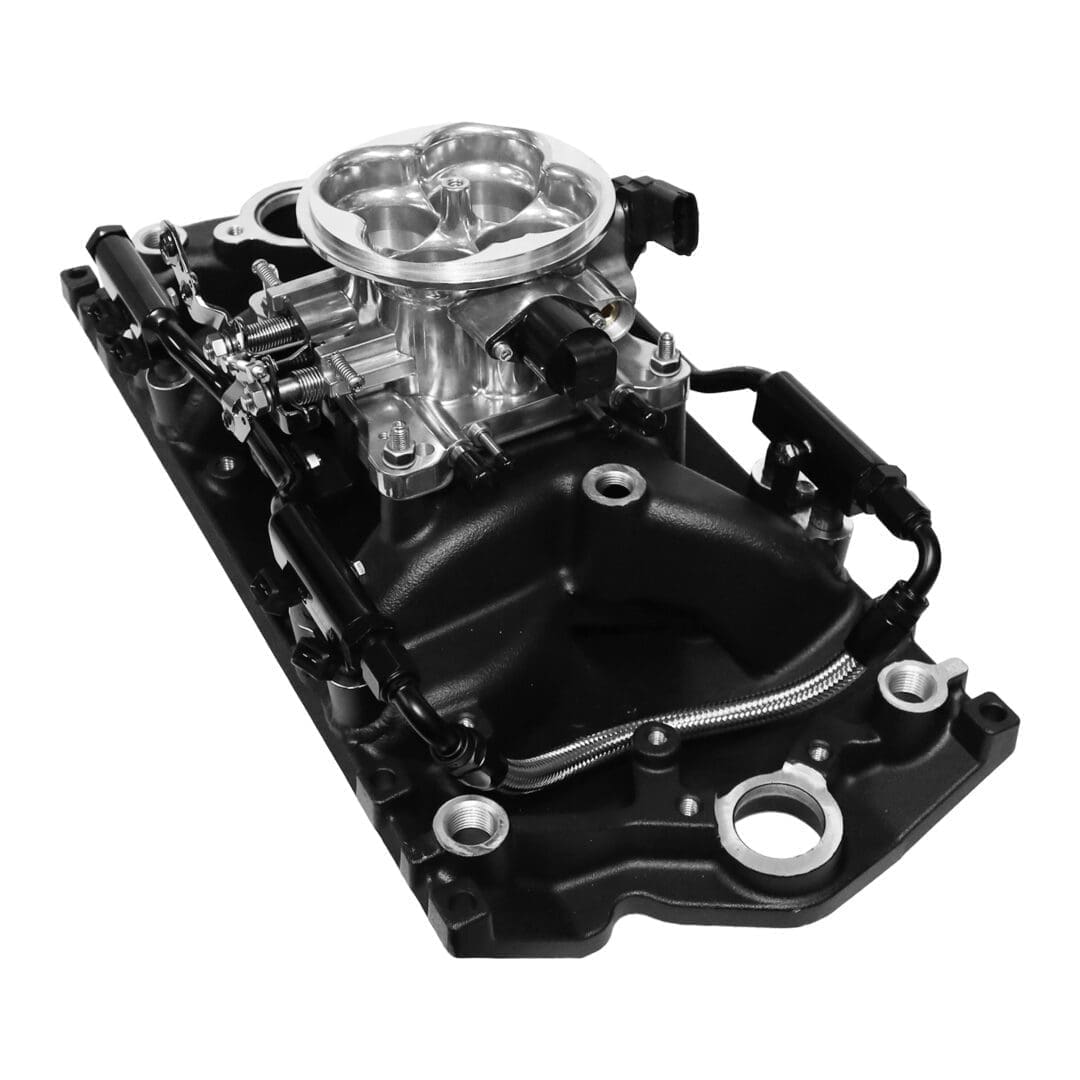 Carburetor on black engine intake manifold.