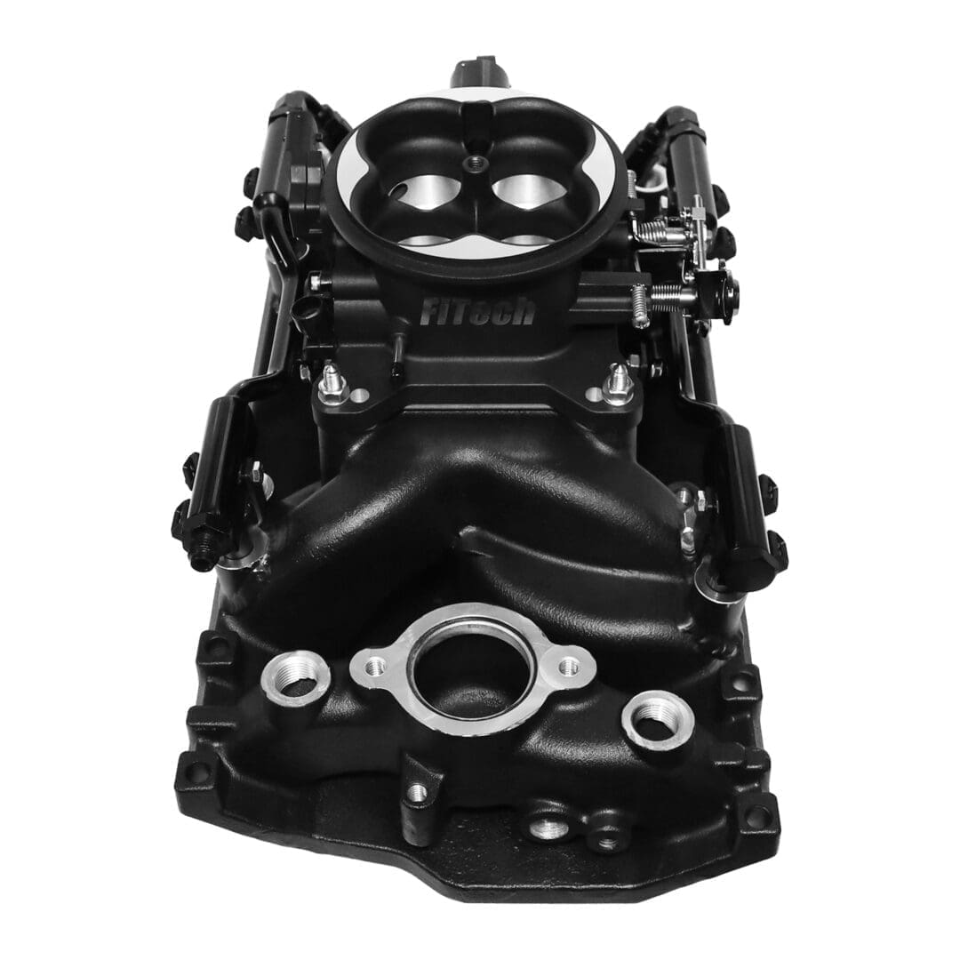 Black automotive engine component, top view.