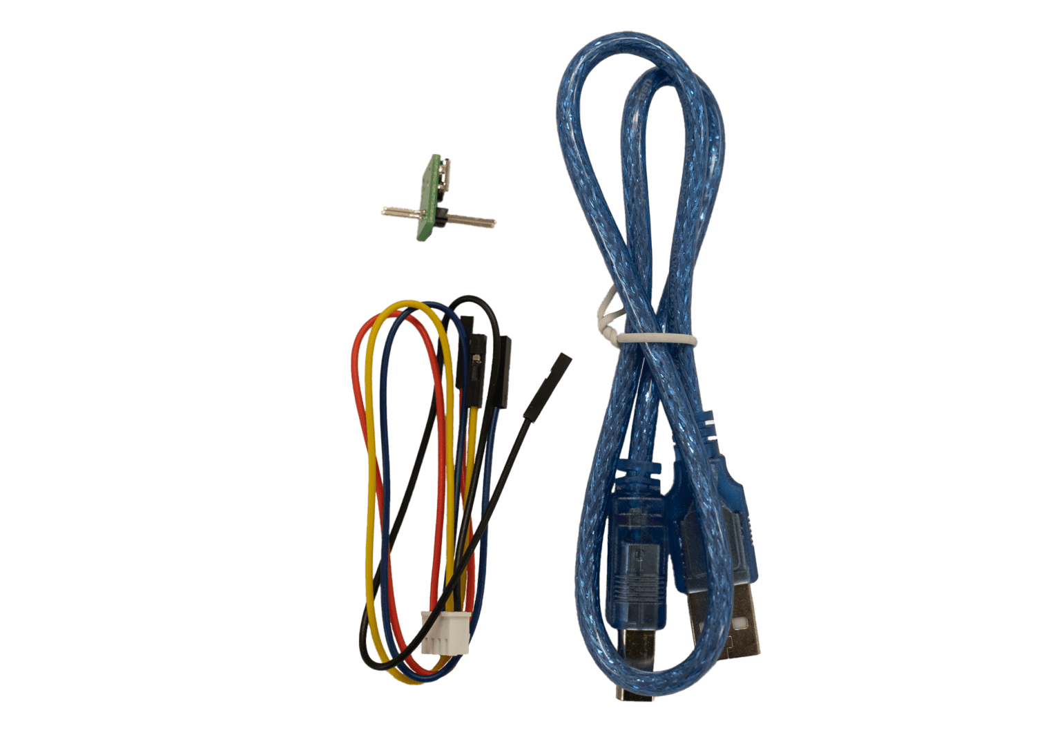 Cables and small electronic component on black.